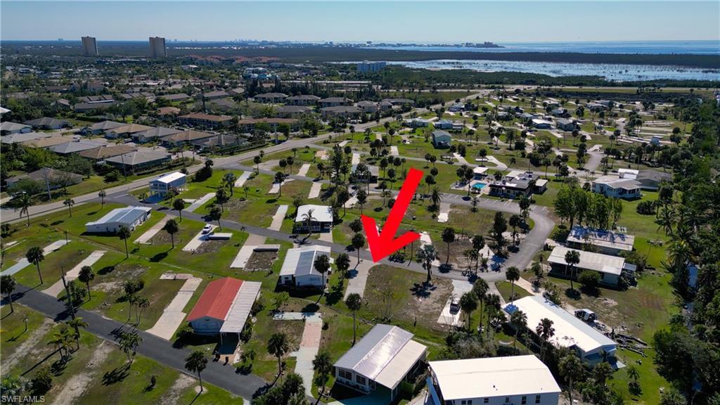 Image 3: Aerial view of property and surrounding area featuring a large body of water and nearby suburban area