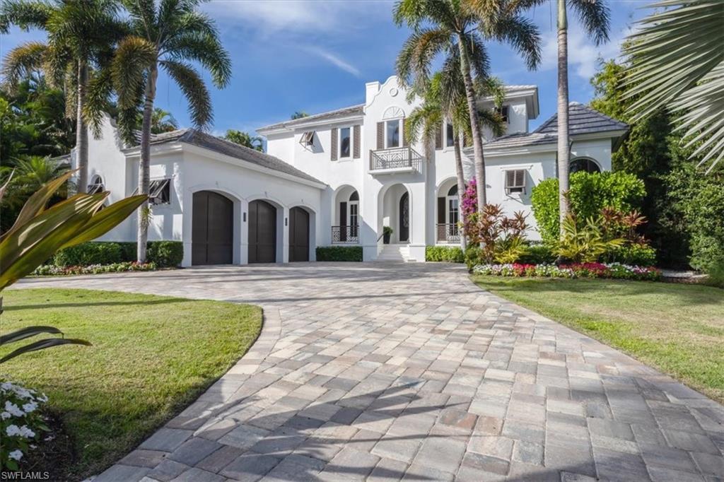 Image 4: Mediterranean / spanish-style home featuring decorative driveway, a front lawn, stucco siding, a balcony, and a garage