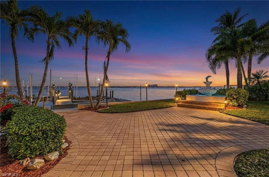 Image 3: View of community featuring boat lift, a water view, a dock, and a patio area