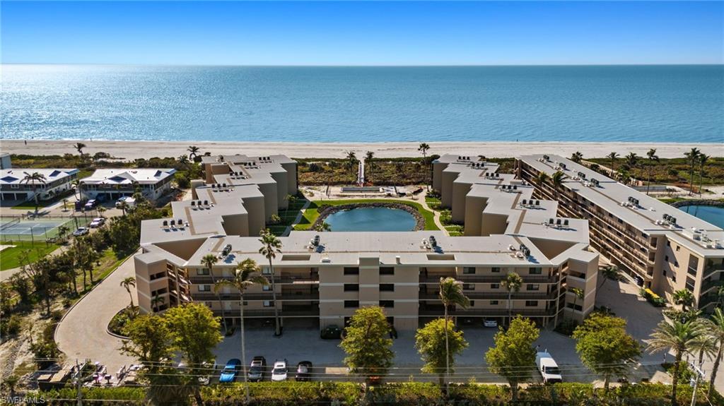 Image 2: Bird's eye view of expansive coastline and apartment complex