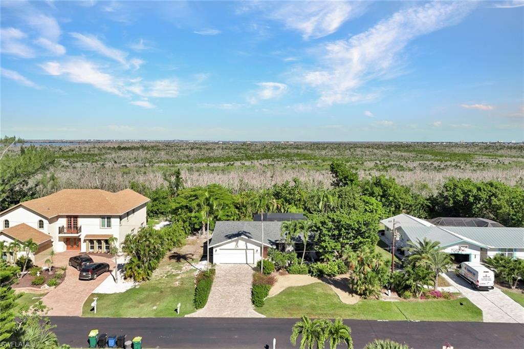 Image 3: Aerial view of property and surrounding area featuring a heavily wooded area