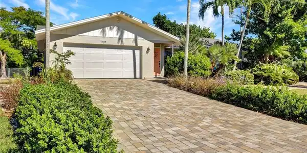 Image 4: View of front of house with decorative driveway and an attached garage