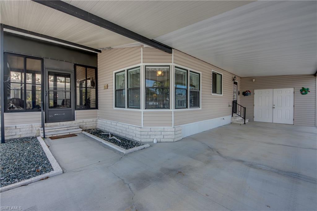 Image 3: Entrance to property with an attached carport