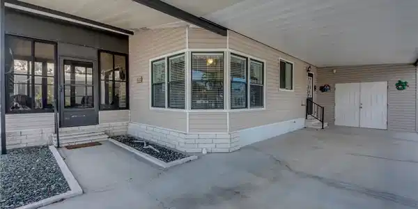 Image 3: Entrance to property with an attached carport