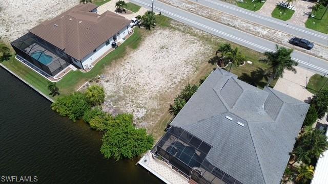 Image 2: Expansive waterfront parcel featuring a natural shoreline, mature vegetation, and direct canal access