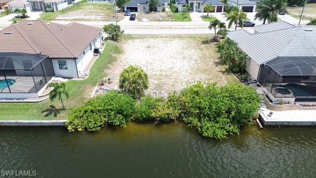 Image 3: Cleared residential lot with mature vegetation at the waterfront