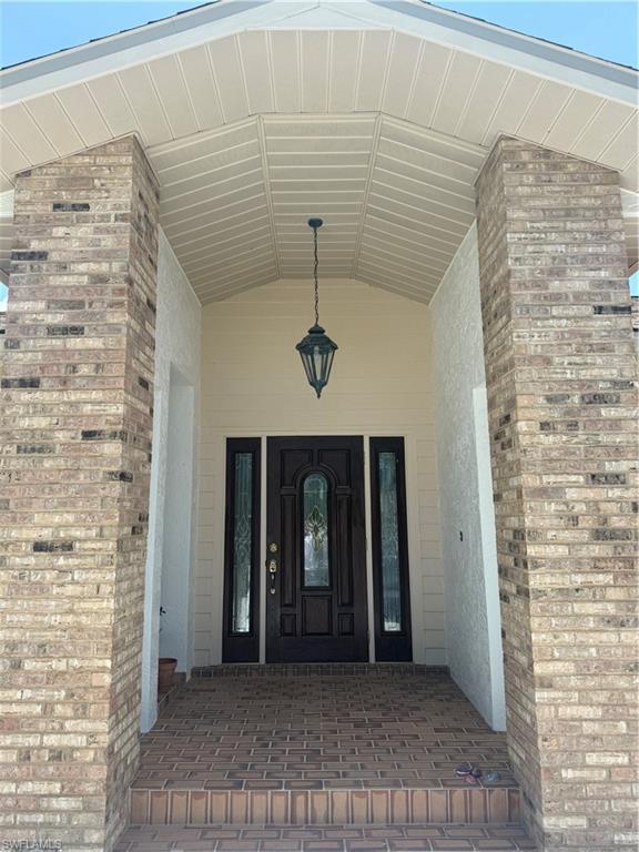 Image 3: Property entrance with stucco siding