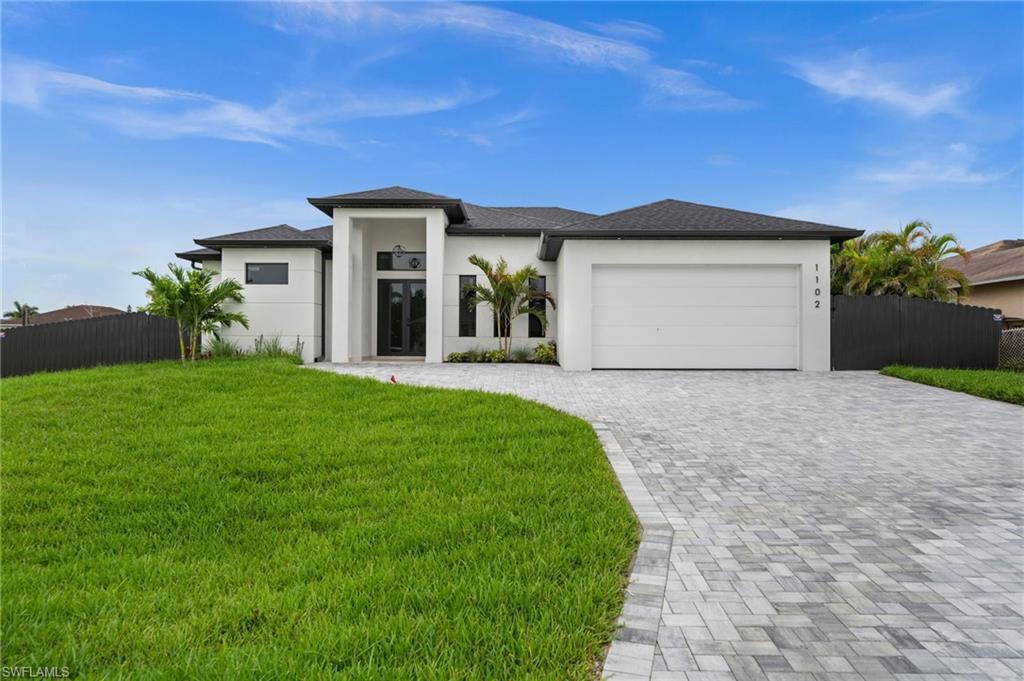 Image 2: Contemporary single-story residence with a white stucco exterior