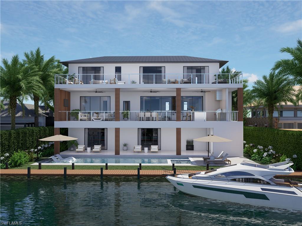 Image 2: Rear view of house featuring water views balconies, pool and spa