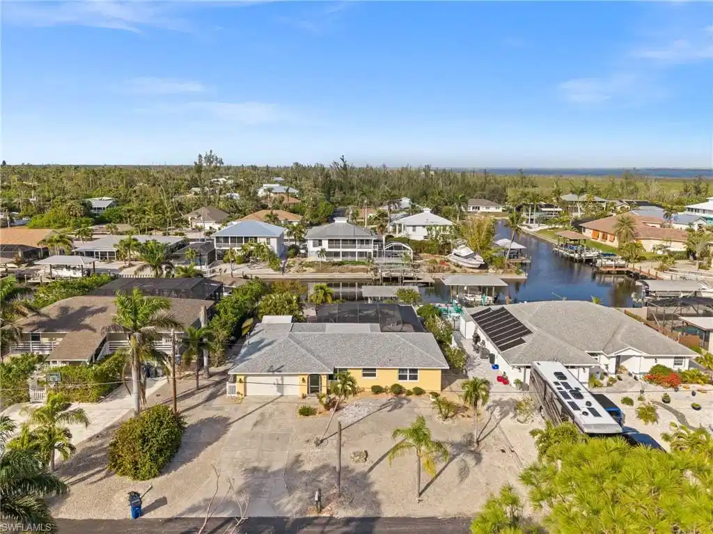 Image 1: Aerial view of residential area with a large body of water
