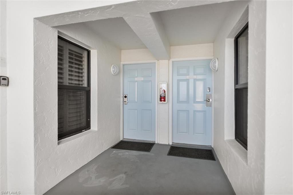 Image 2: Property entrance with stucco siding