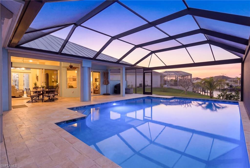 Image 2: Dive into luxury in this oversized heated saltwater pool surrounded by elegant travertine decking.