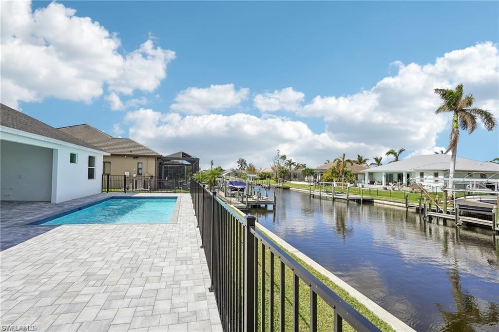 Image 2: View of pool with a dock and a water view