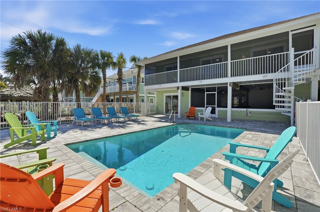 Image 2: View of swimming pool with patio surround, a balcony, and a sunroom - Virtually Edited Image