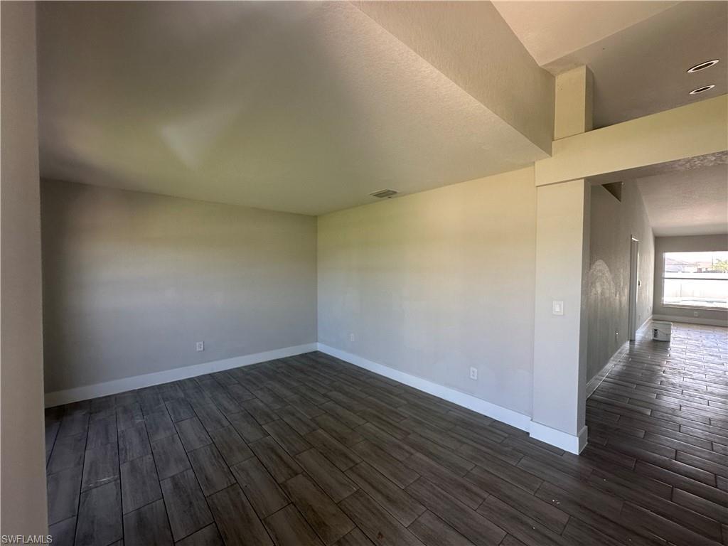 Image 2: Spare room with wood finish floors and a textured ceiling