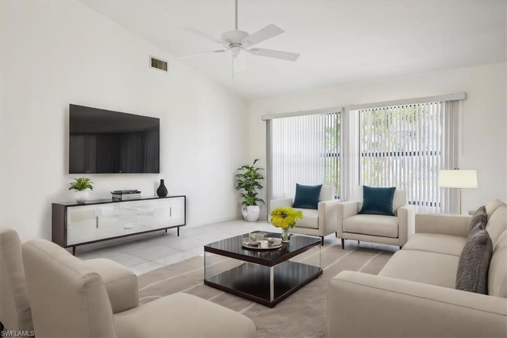 Image 2: Living area featuring a ceiling fan and lofted ceiling