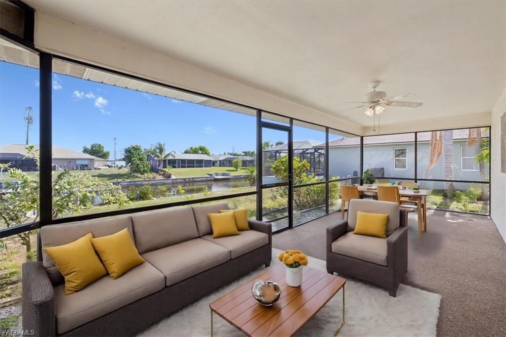 Image 3: Sunroom with an outdoor living space, ceiling fan, outdoor dining area, and a residential view
