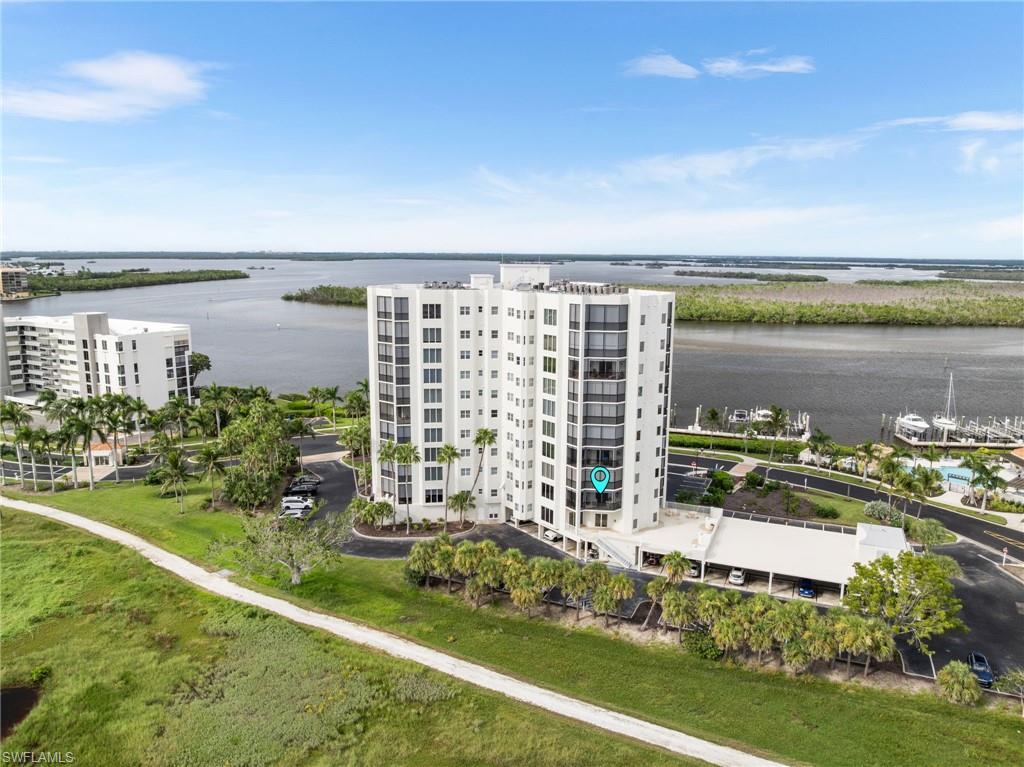 Image 2: Drone / aerial view of apartment complex and a nearby body of water