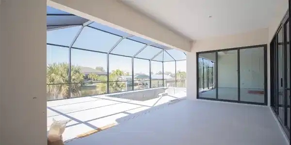 Image 3: View of patio / terrace featuring a lanai, a sunroom, an outdoor pool, and a water view
