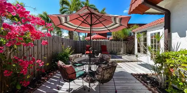 Image 2: Townhome features a Large Private Courtyard with Patio Tables, Umbrellas and lounge chairs. Your Private Slice of Paradise in the Sun! Lovely Heated Pool is just steps from your gate !