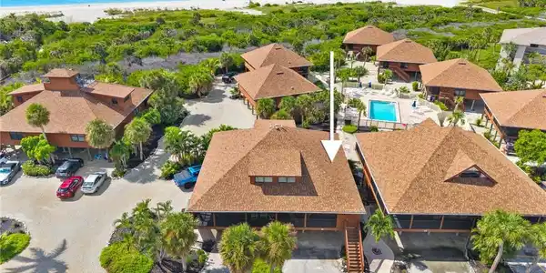 Image 3: Aerial view of a pool area and extended coastline