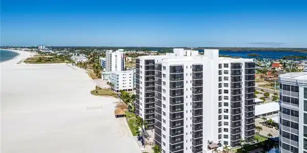 Image 2: Bird's eye view of the wide beach in front of Island Winds