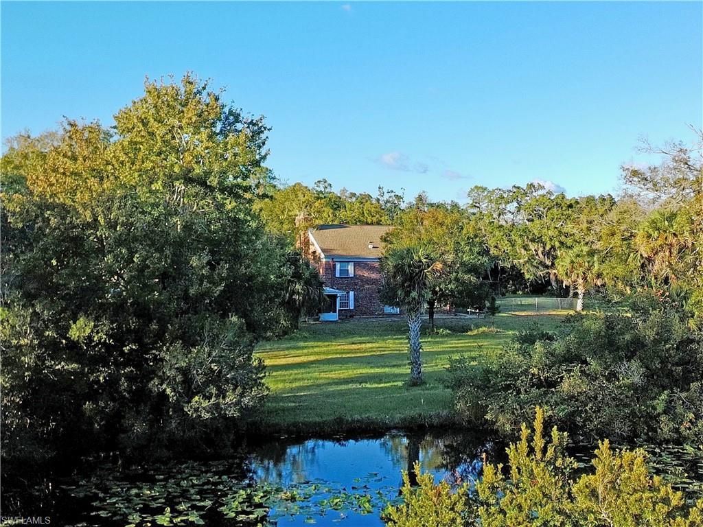 Image 2: View of front of property overlooking the pond