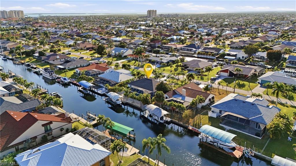 Image 2: View of property location with a nearby body of water and nearby suburban area