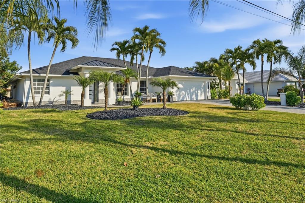Image 4: Single story home featuring an attached garage, driveway, stucco siding, and a front yard