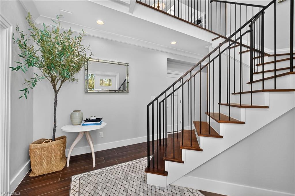 Image 4: Staircase with wood finished floors and recessed lighting
