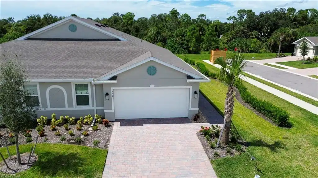 Image 1: View of front of property with garage