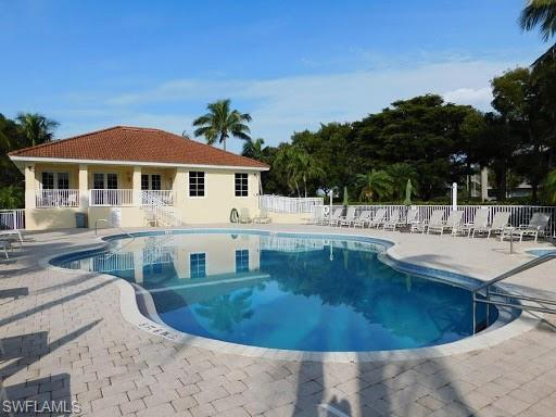 Image 3: Community pool with a patio