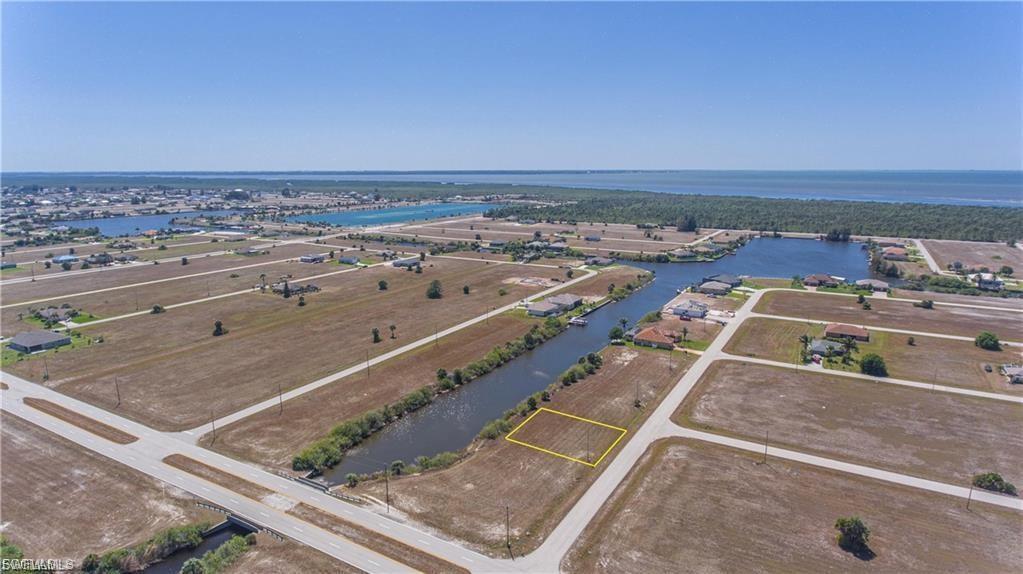 Image 2: Aerial overview of property's location featuring property parcel outlined and a large body of water