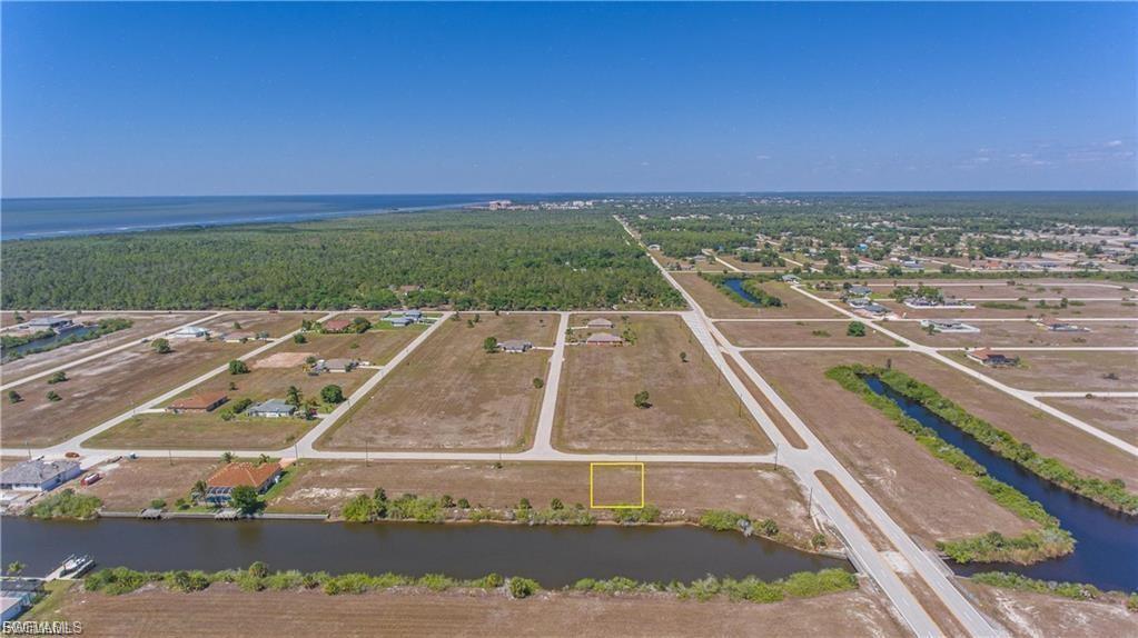 Image 4: Bird's eye view of a nearby body of water and a heavily wooded area
