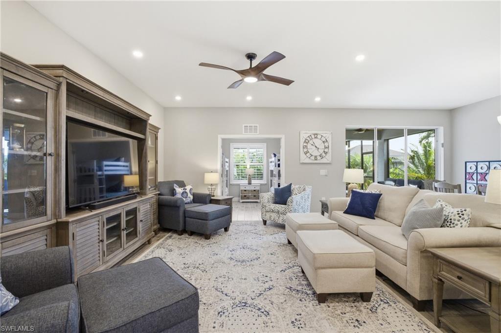 Image 4: Spacious living area featuring light-toned walls and wood-finish flooring