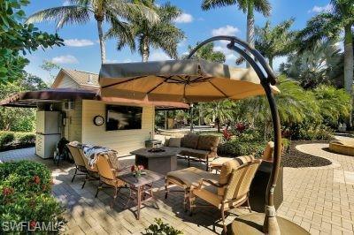 Image 4: View of patio / terrace with an outdoor living space with a fire pit