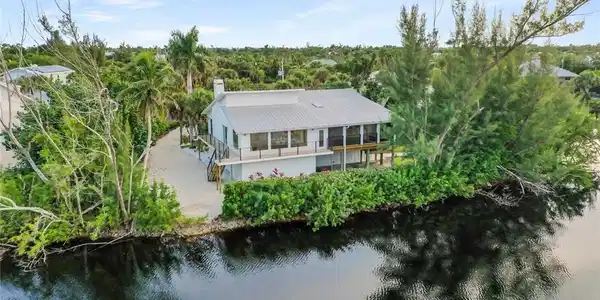 Image 3: Aerial view of property and surrounding area featuring a nearby body of water