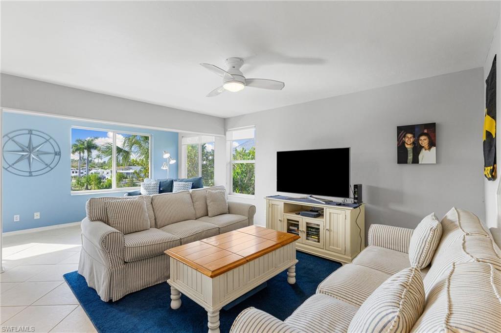 Image 4: Tiled living room with a ceiling fan and baseboards