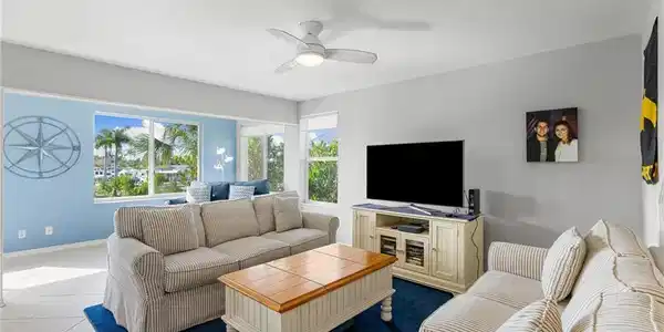 Image 4: Tiled living room with a ceiling fan and baseboards