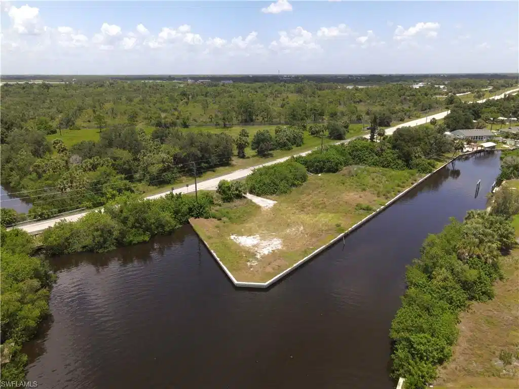 Image 1: 4 lots on the corner of an intersecting canal one block in from the Peace River with Direct Gulf Access! Cleared with seawall in place - build your dream home here!