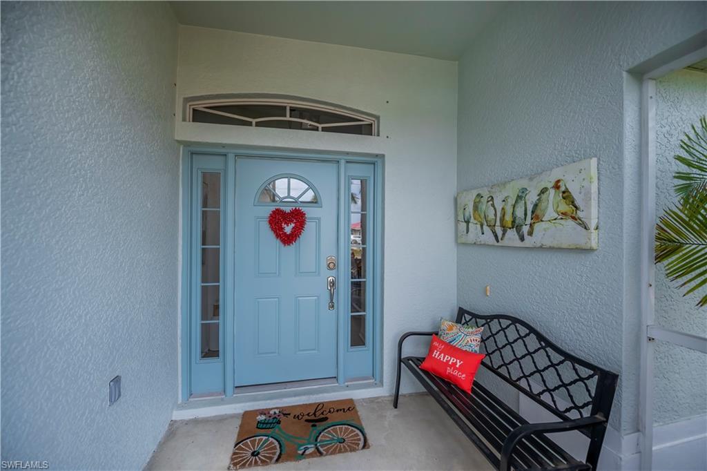 Image 4: Property entrance with stucco siding and covered porch