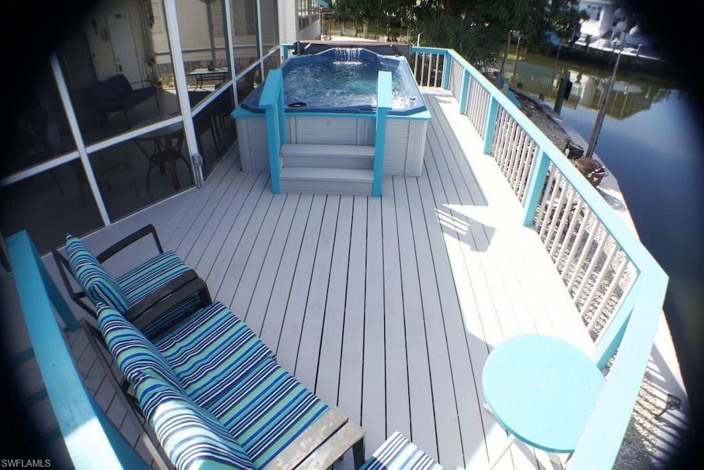 Image 3: Wooden deck with a hot tub