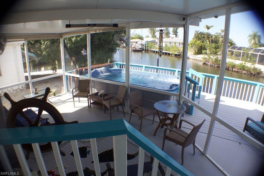 Image 4: Sunroom with a water view and a hot tub
