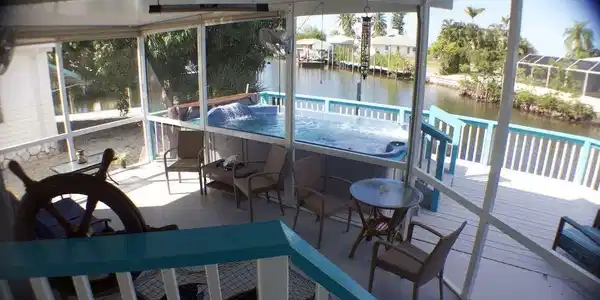 Image 4: Sunroom with a water view and a hot tub