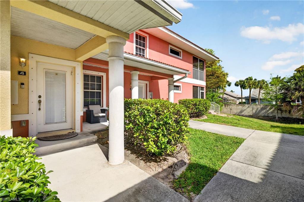 Image 3: Entryway featuring a white door with frosted glass, exterior sconce lighting, and a concrete stoop