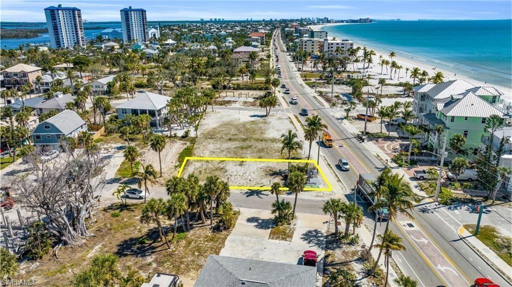 Image 2: Aerial perspective of suburban area featuring unending shoreline and property parcel outlined - VIRTUALLY EDITED