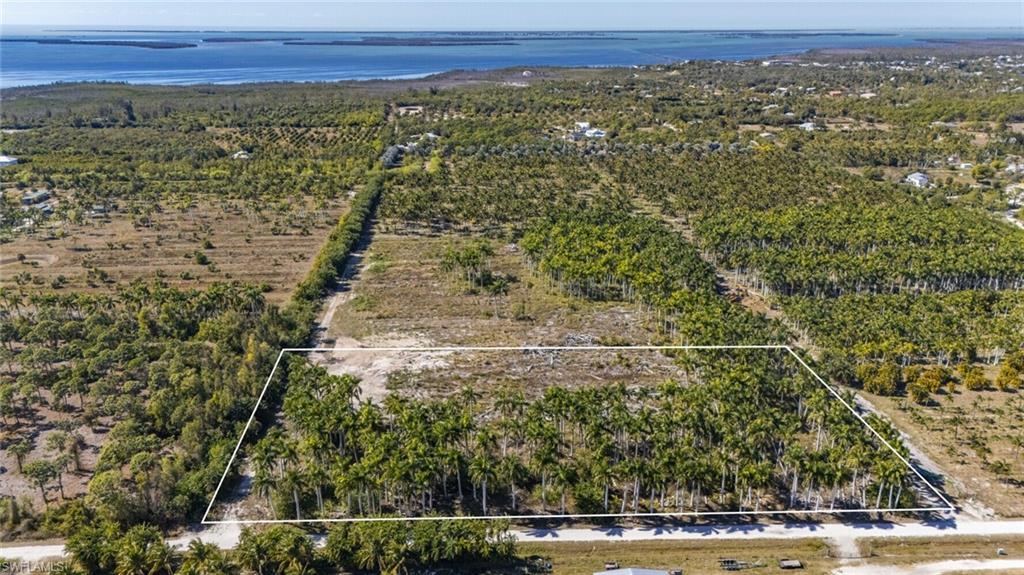 Image 1: Overview of rural landscape with property parcel outlined and a nearby body of water