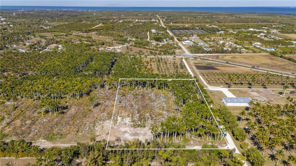 Image 3: Aerial view of property's location featuring rows of crops, rural landscape, and property boundaries highlighted