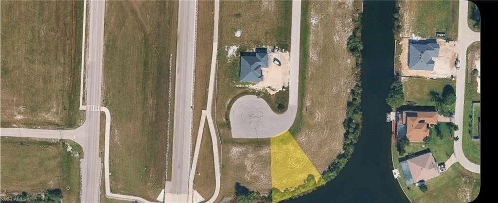 Image 2: Aerial overview of property's location with a nearby body of water