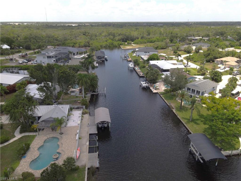 Image 4: Aerial View from the Peace River looking down the canal. 25301 Harborview Rd. is in the background on the right of the main canal